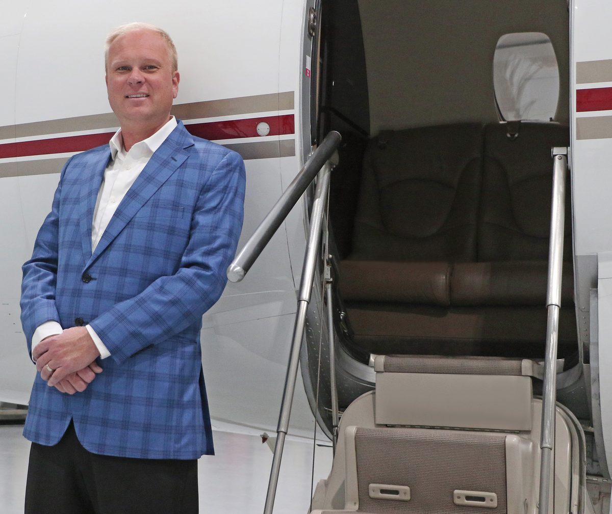 Corey Tomczak, founder and principal of Gateway Jets, standing at the airstair of a Citation
