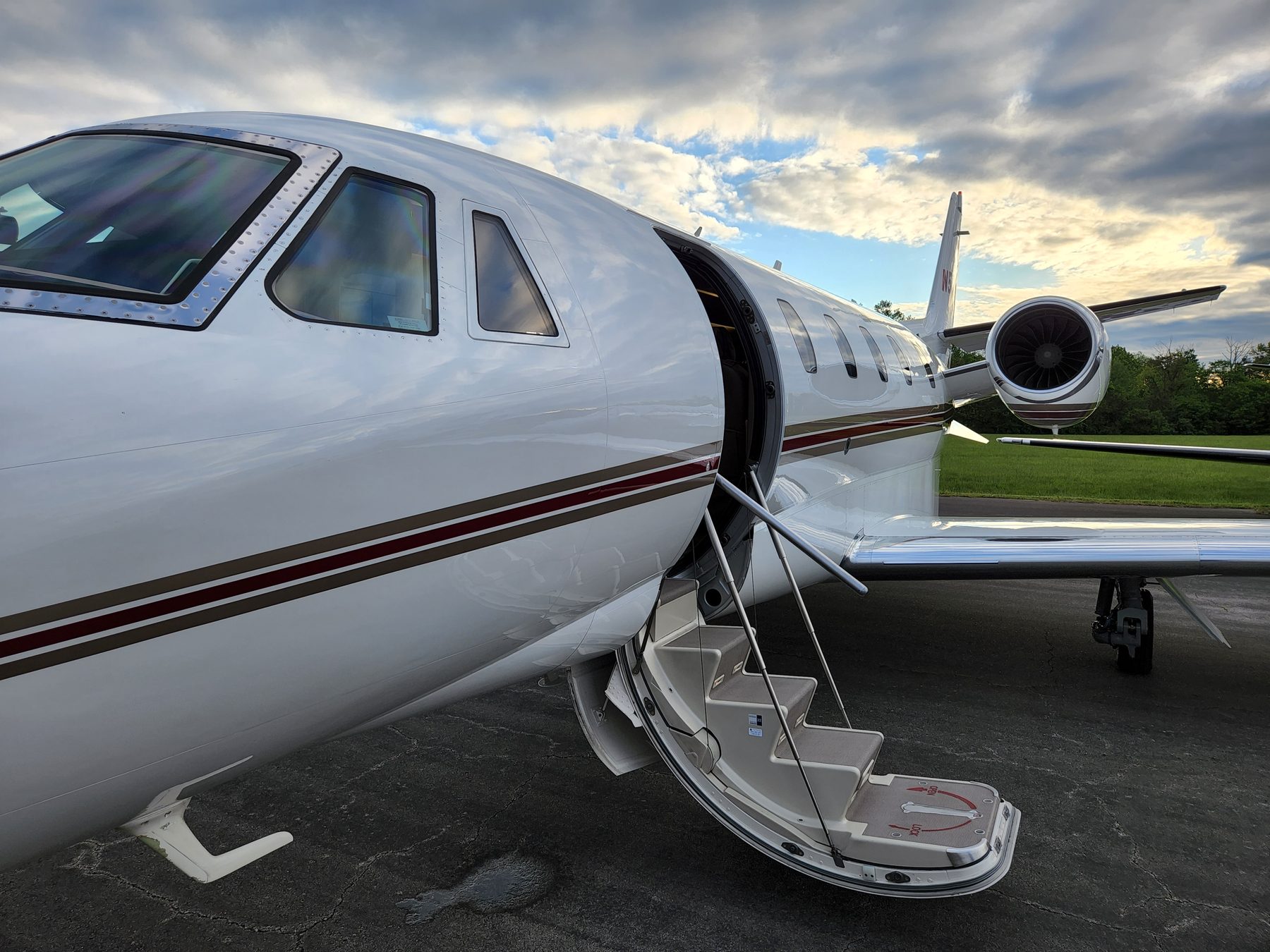 Citation Excel with the airstair door open under a dramatic sky