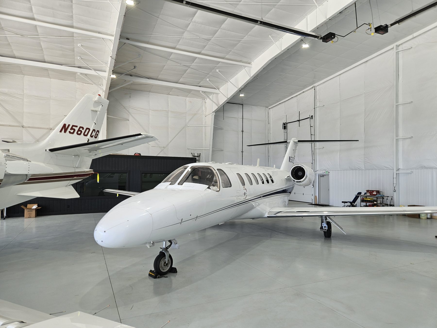 A Citation CJ2 parked inside the Gateway Jets hangar beside a Citation Excel
