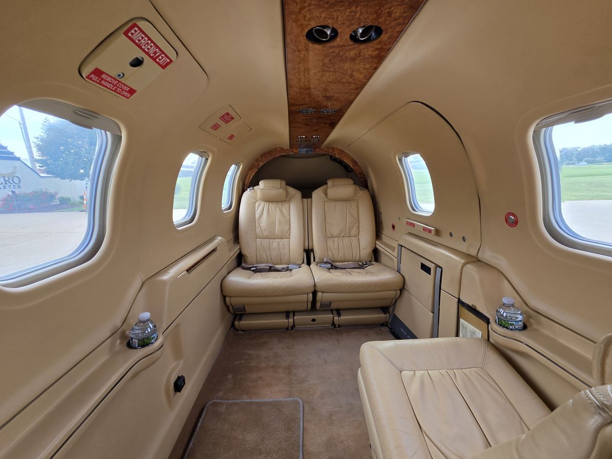 Cabin of TBM 700C2 N6272B looking aft, showing the full six-place seating arrangement and cabin width