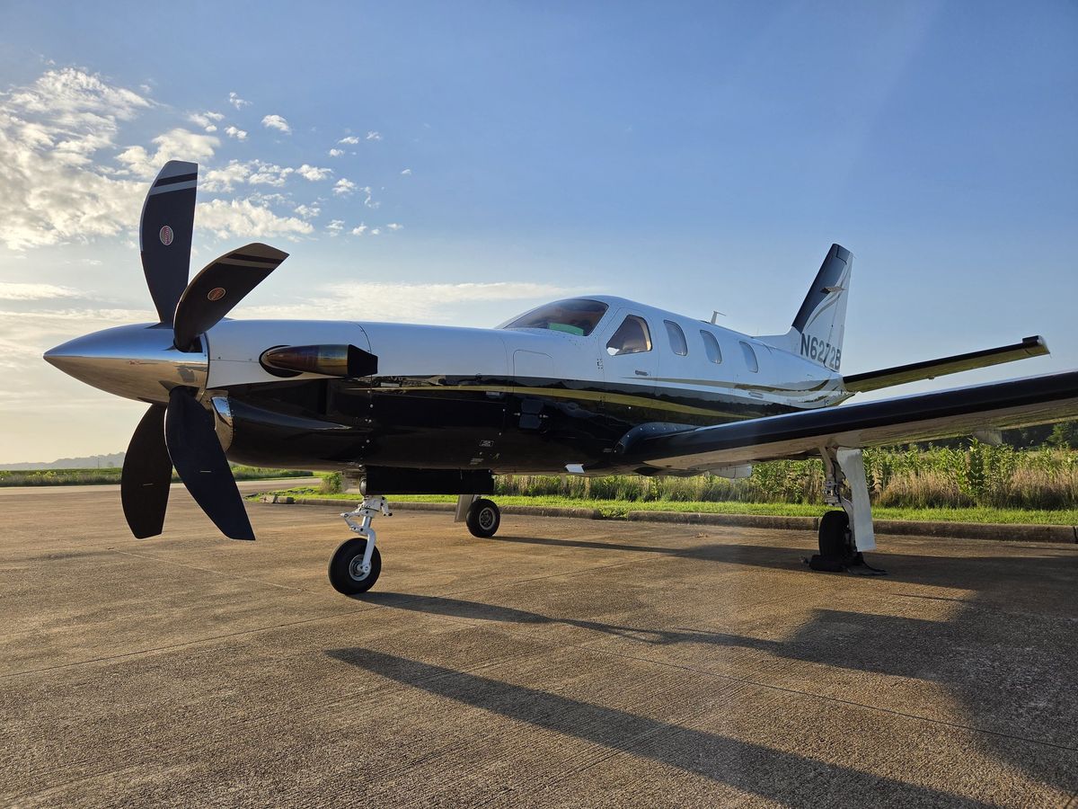 2005 Socata TBM 700C2 N6272B on the ramp at sunrise, five-blade Hartzell propeller and polished spinner in the foreground