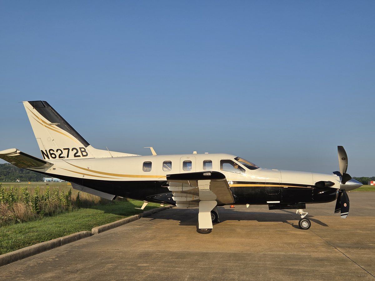 Level side profile of the 2005 TBM 700C2 N6272B on the ramp under clear skies