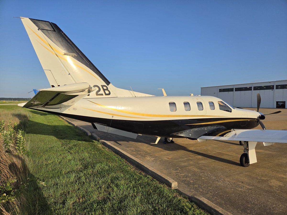 Rear three-quarter view of TBM 700C2 N6272B showing the tail, registration, and gold accent striping